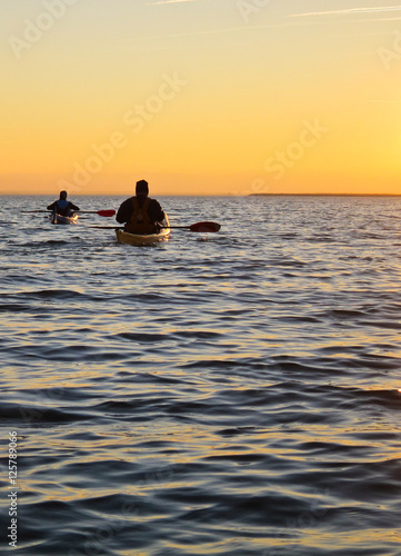 Kayaking at sunset on calm lake