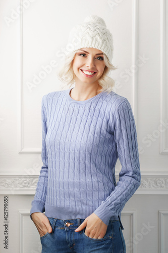 Young woman in a white hat and a blue sweater