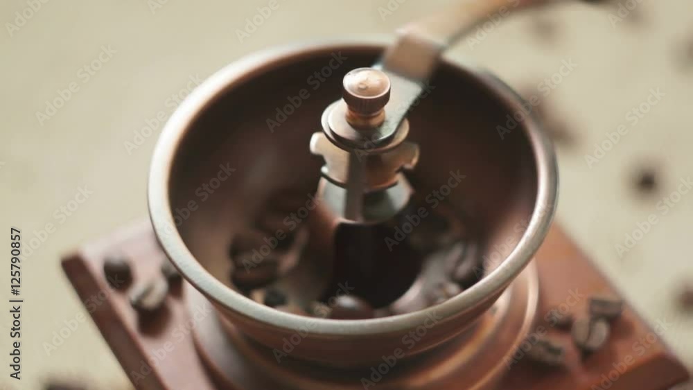 Grinds coffee beans with an old Coffee grinders Grinds coffee beans with an old Coffee grinders