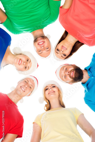 Group of happy teenagers in Christmas hats