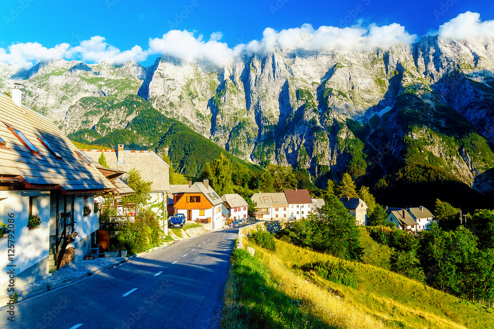 picturesque road in beautiful alpine landscape with big mountains and small villages