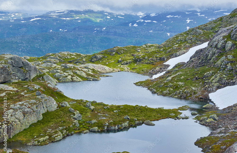 Obraz premium Tarn at the top of the mountains with summer snow at Stordalsnippa near Roeldal in Norway