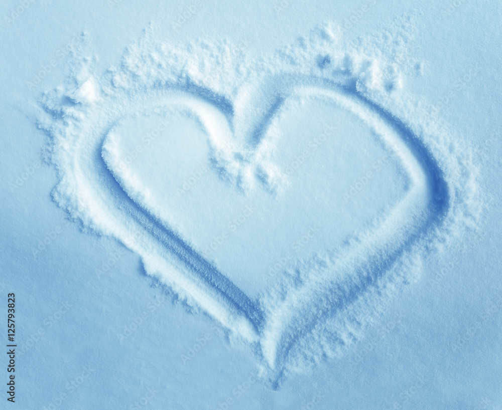 heart in snow, drawing in the snow. Light blue background. heart in snow, drawing in the snow. Light blue background.