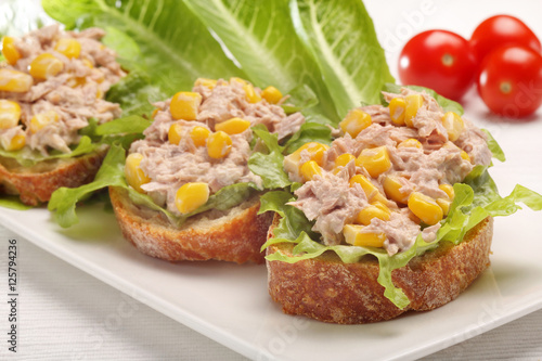 Tuna sandwich with corn on white background