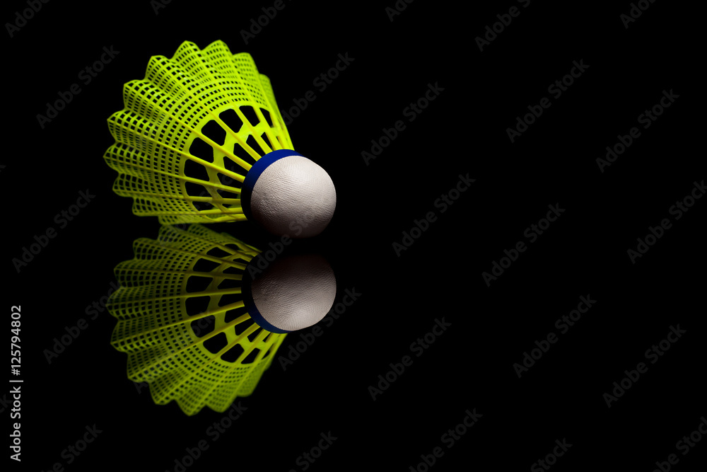 Yellow plastic shuttlecocks with blue strip isolated on black re Yellow plastic shuttlecocks with blue strip isolated on black re