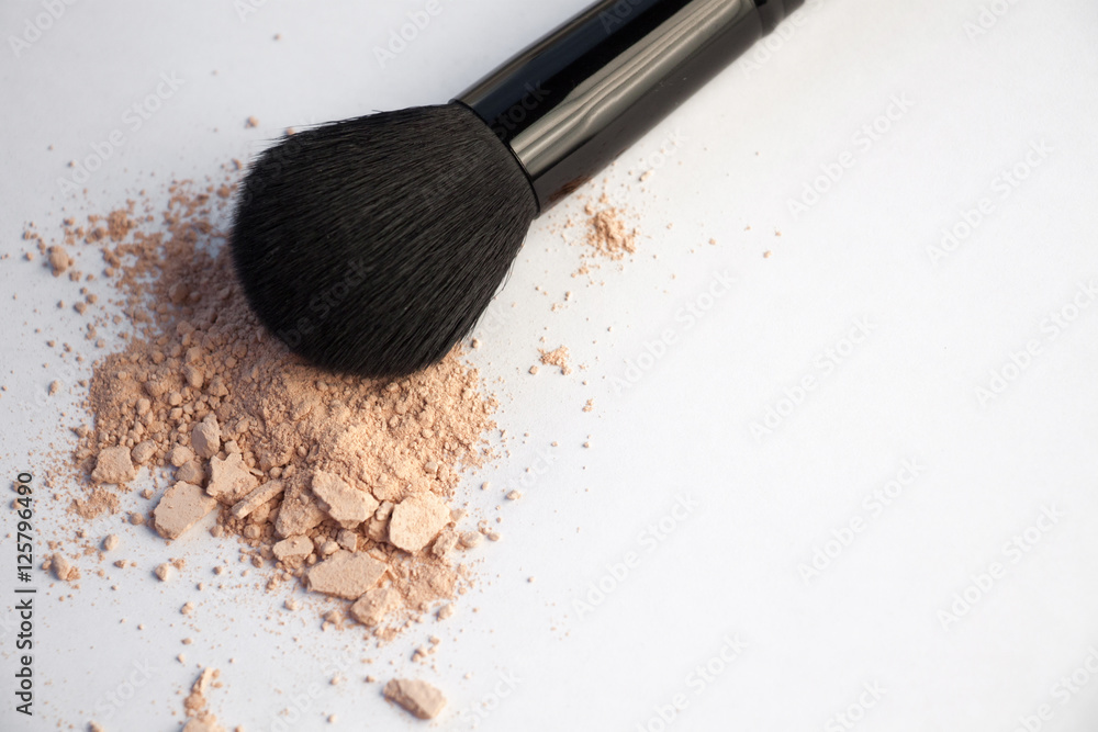 cosmetic brush and flask with powder on a white background cosmetic brush and flask with powder on a white background