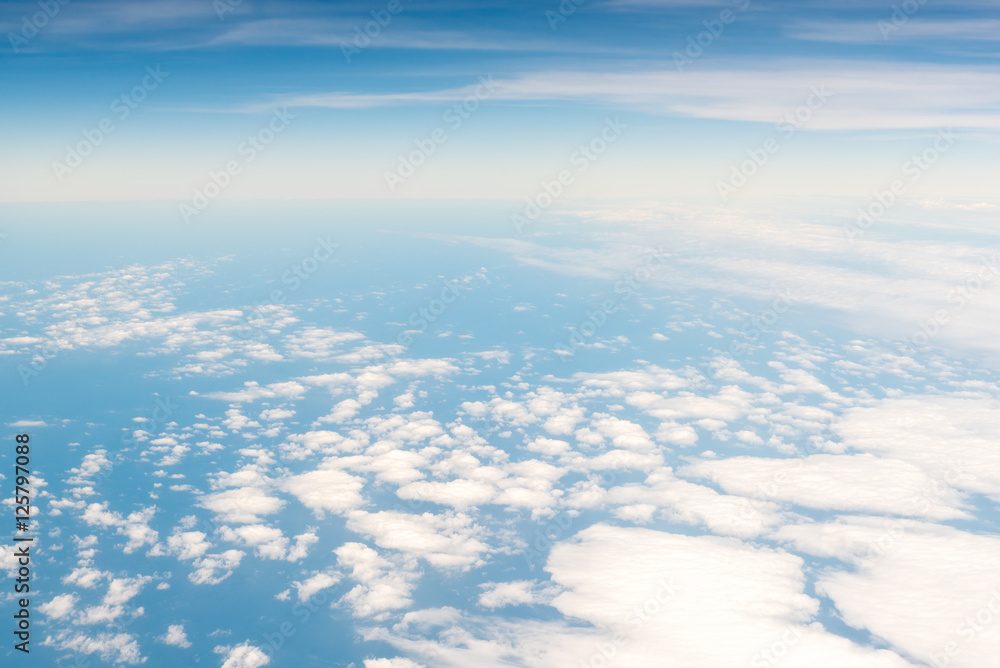 Cloudscape skyline view above white clouds and blue sky Cloudscape skyline view above white clouds and blue sky