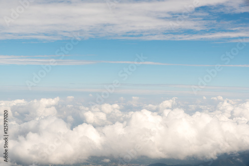 Fototapeta Naklejka Na Ścianę i Meble -  Cloudscape view above white clouds and blue sky from airplane