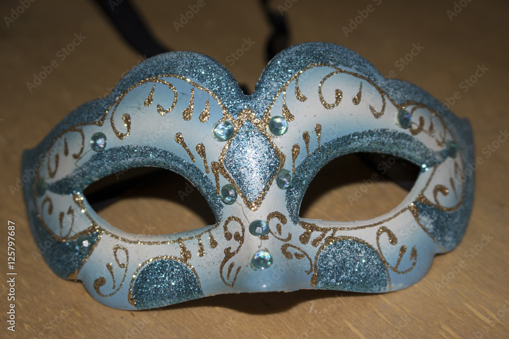 Carnival mask on brown wood background