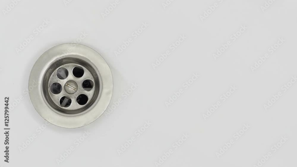 Water stream going down the drain.
Water stream going down the drain.