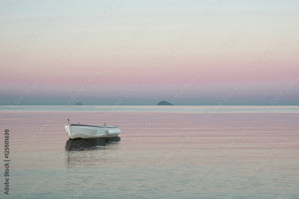 Wood boat with staying on the mistic quiet Sardinia sea water by sunset