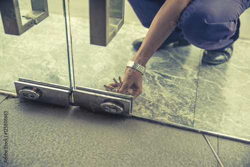 Hand inserting keys in door lock close up