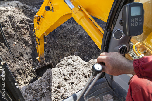 excavator digging hole ground