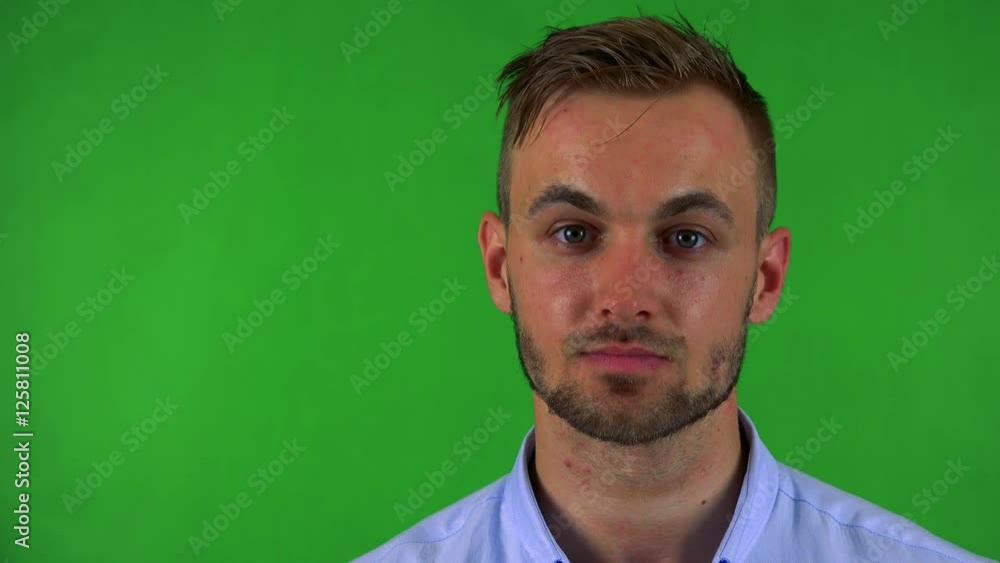 young handsome business man looks to camera with serious face - green screen young handsome business man looks to camera with serious face - green screen