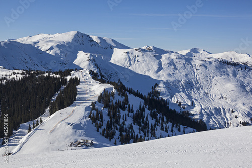 Ski slope in the sunny day on the background of the Ausrtian Alp photo