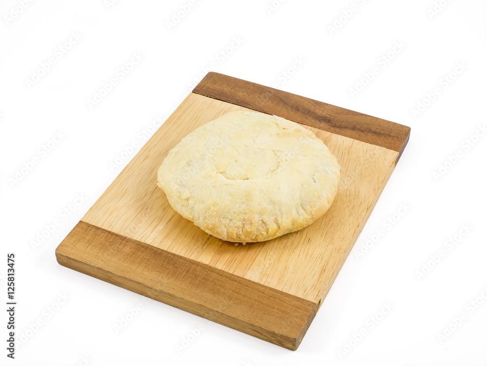 The Taiwanese sun cake (milk butter pastry) on the brown wooden plank. The Taiwanese sun cake (milk butter pastry) on the brown wooden plank.