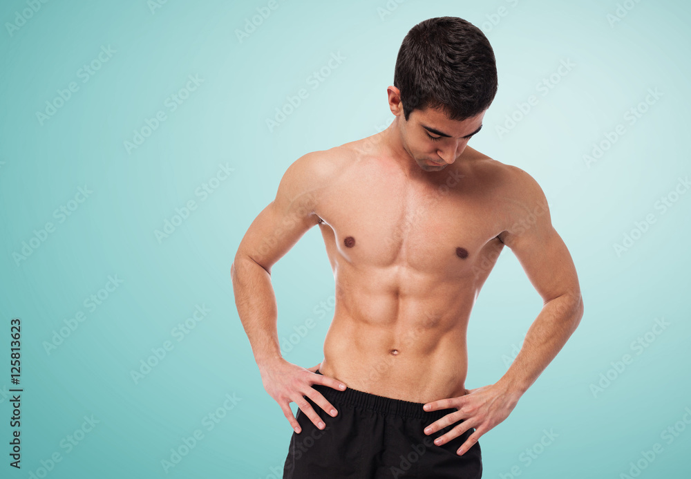 Fototapeta premium closeup of a strengh fitness body over white