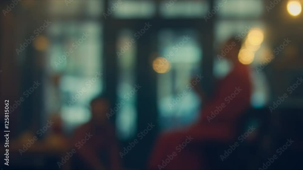 Defocused background - a people sit in a modern cafe. 4K UHD Defocused background - a people sit in a modern cafe. 4K UHD