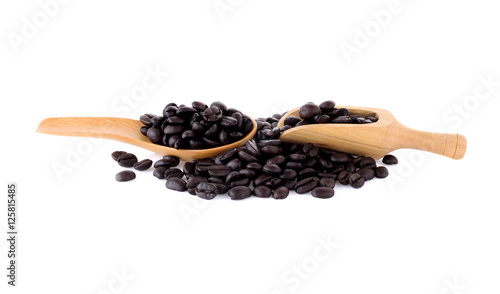 Fresh coffee beans in  wooden scoop and wooden spoon  isolated o