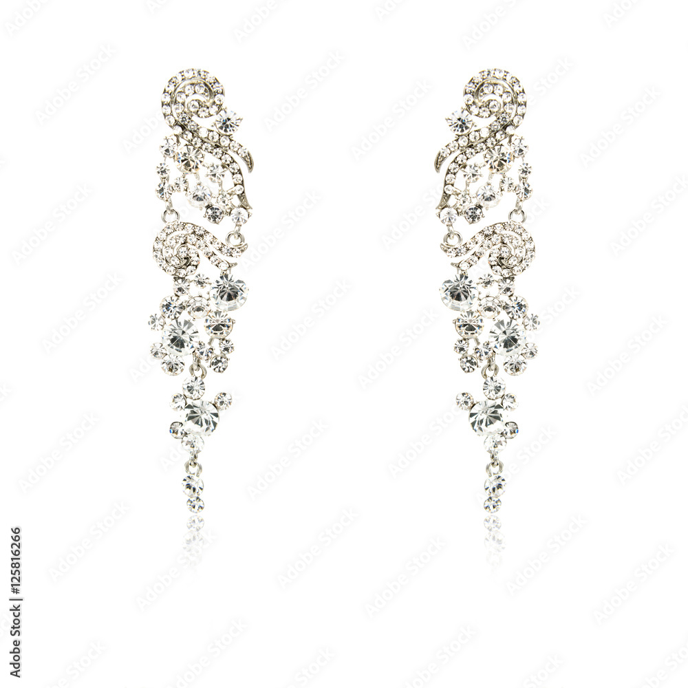 Pair of silver diamond earrings isolated on white Pair of silver diamond earrings isolated on white