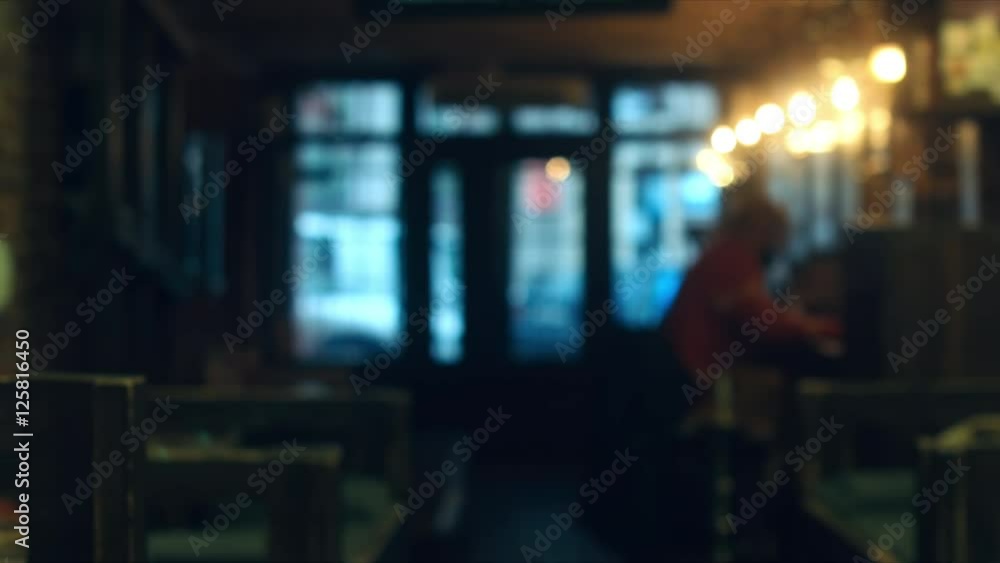 Defocused background - a people sit in a modern cafe. 4K UHD Defocused background - a people sit in a modern cafe. 4K UHD