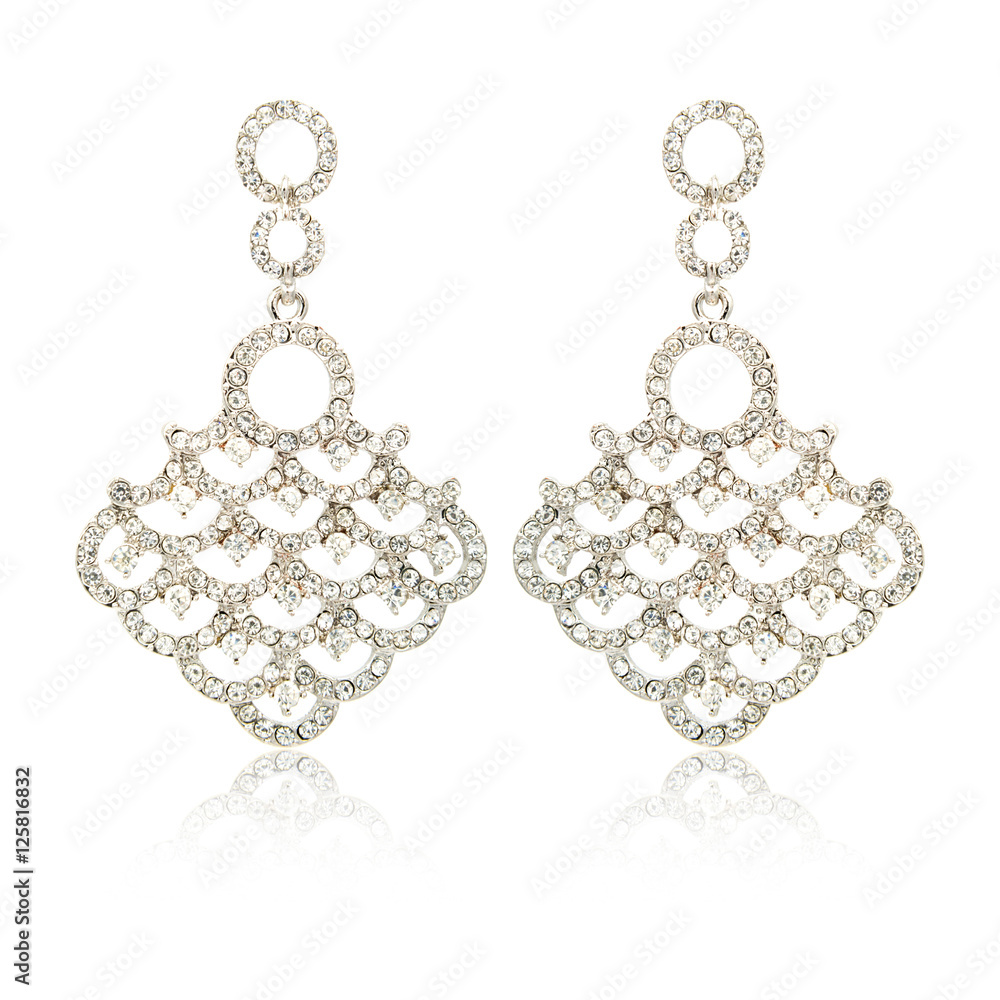 Pair of silver diamond earrings isolated on white Pair of silver diamond earrings isolated on white
