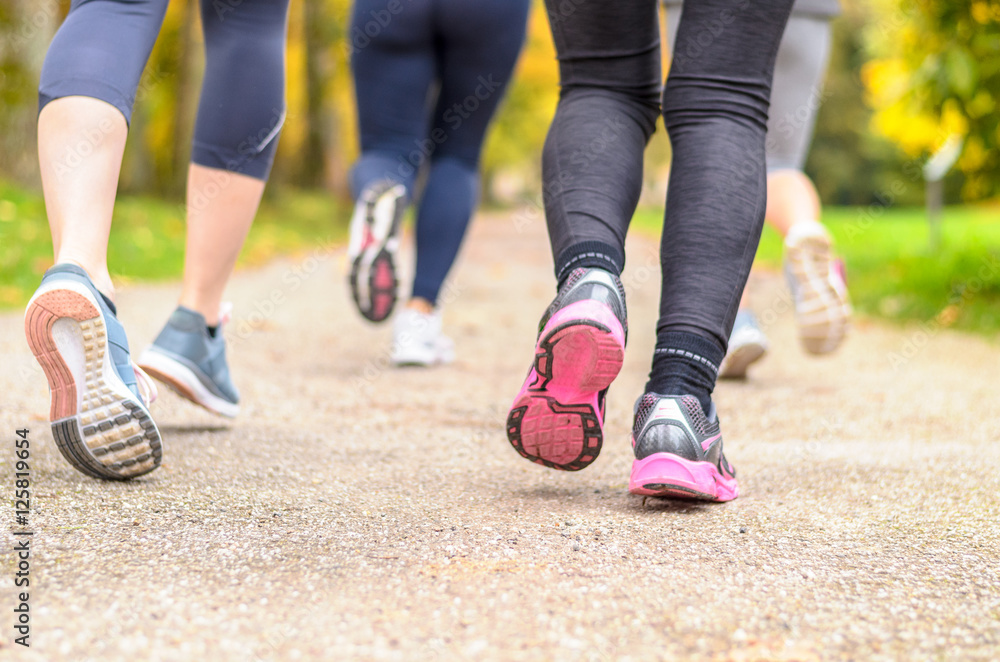Group of young woman jogging together in a park Group of young woman jogging together in a park