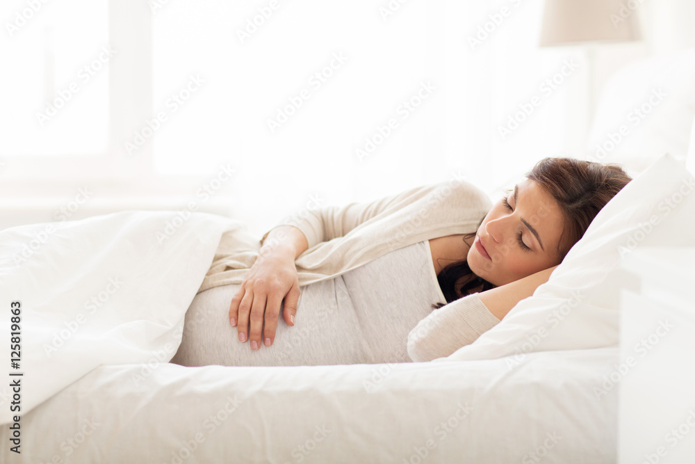 happy pregnant woman sleeping in bed at home happy pregnant woman sleeping in bed at home