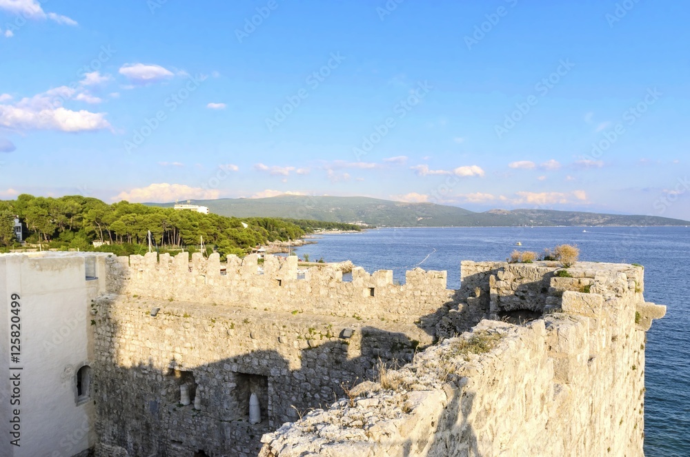     The interior of the Frankopan Castle, at Kamplin square in Krk, Croatia - Frankopanski Kastel, part of the medieval city walls. View of the archer loop holes and sea port of the island 