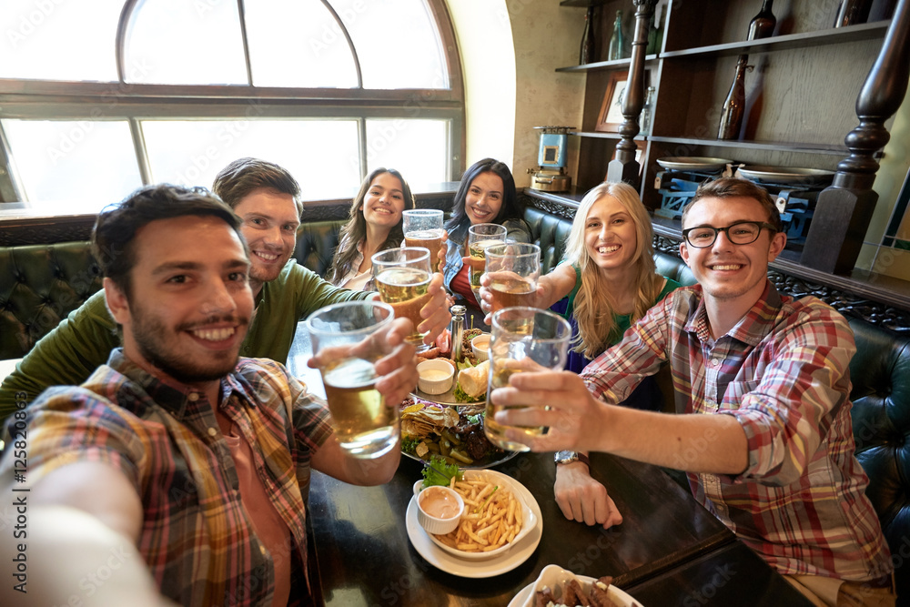 happy friends taking selfie at bar or pub happy friends taking selfie at bar or pub