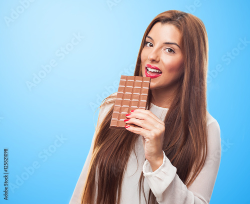 portrait of young woman holding a chocolate bar