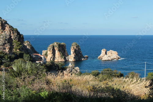 Faraglioni che si stagliano sul mare  photo