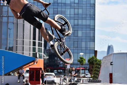 BMX sport jumping at a city background. Biking as extreme and fun sport.