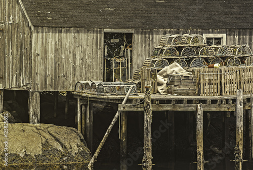 Wooden fishing pier with lobster traps set up and ready for a day of fishing photo