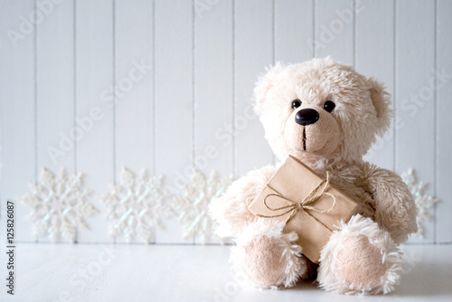  White Christmas background with teddy bear - selective focus, copy space