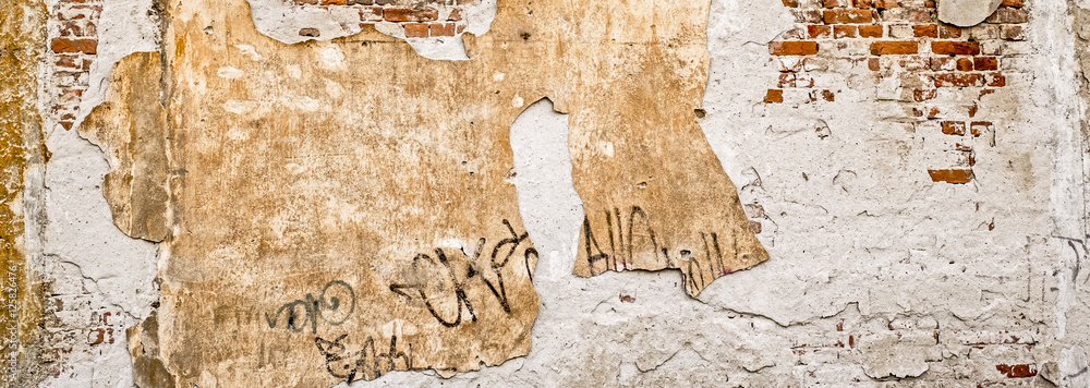 Fototapeta premium Old brick wall with plaster fallen
