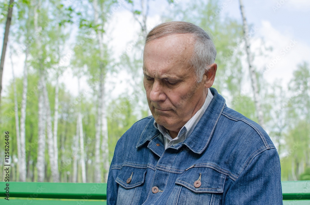Aged man is making notes in the daily planner Aged man is making notes in the daily planner