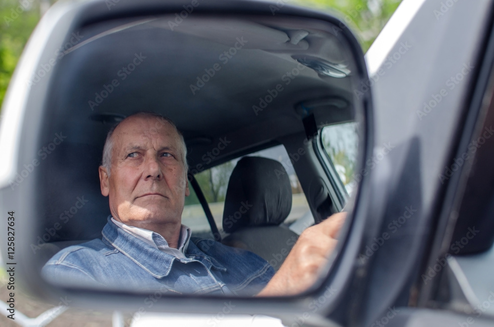 Aged man sitting in the car Aged man sitting in the car