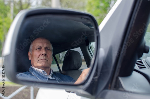 Aged man  sitting in the car © retoncy