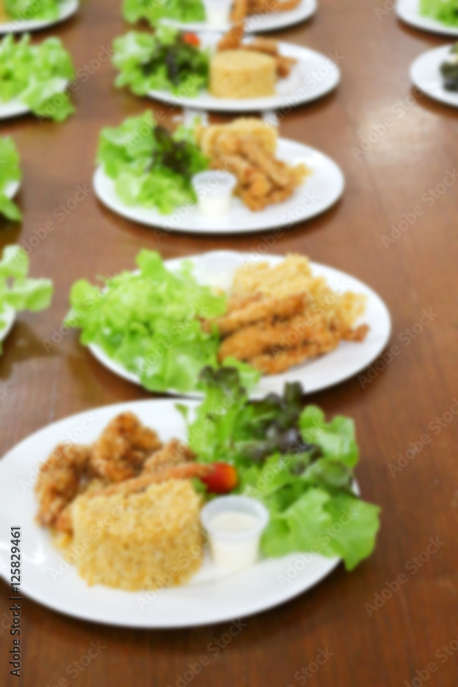 blurred of food, fried rice and breaded fried chicken in white p blurred of food, fried rice and breaded fried chicken in white p