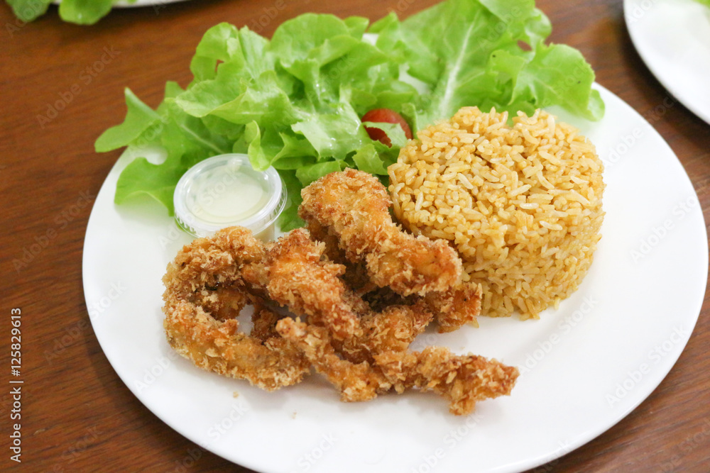 fried rice and breaded fried chicken in white plate fried rice and breaded fried chicken in white plate