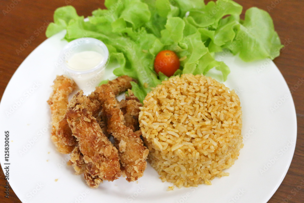fried rice and breaded fried chicken in white plate fried rice and breaded fried chicken in white plate