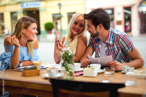 Group of young people laughing in cafe