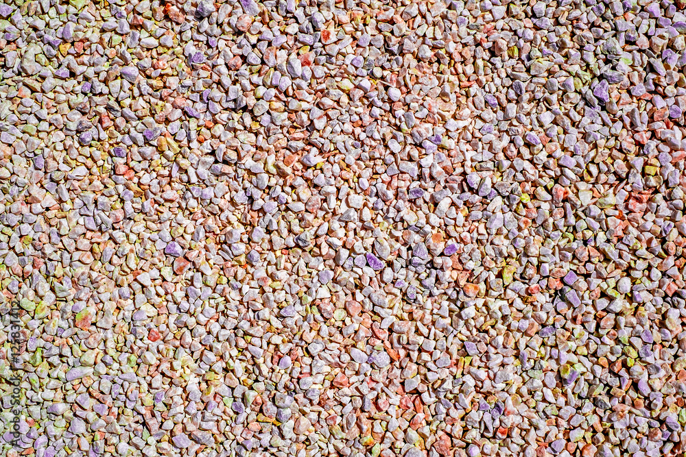 Small multicolored stone gravel covered surface fragment as abstract background texture Small multicolored stone gravel covered surface fragment as abstract background texture
