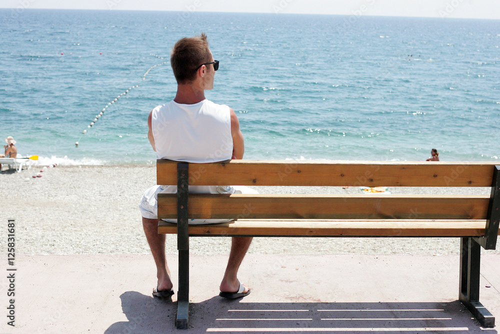Man sitting on a bench and looking at the landscape