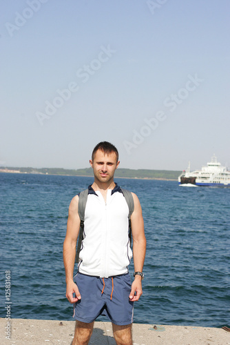 Serious man standing in the sea port