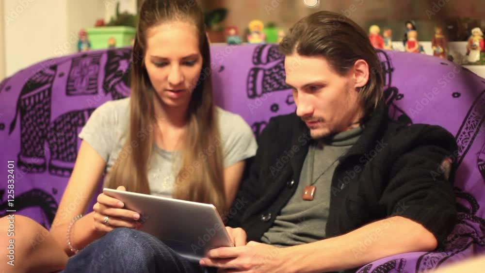 the guy with the girl looking at tablet the guy with the girl looking at tablet