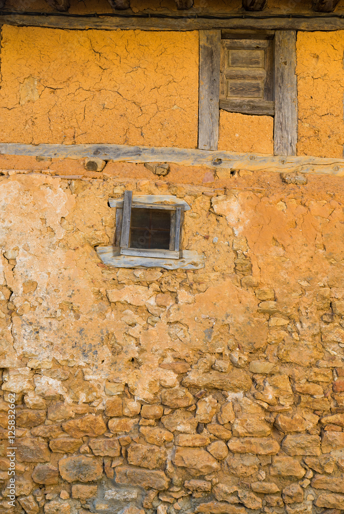 Medieval adobe house facade in Calatanazor, Spain