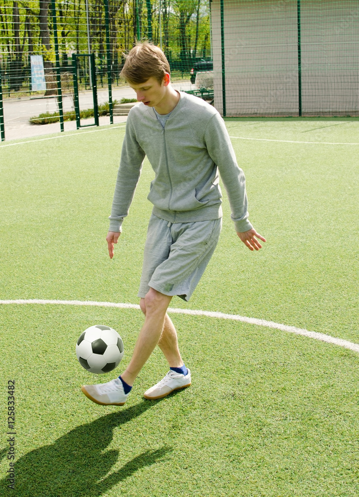 Young man making football freestyle