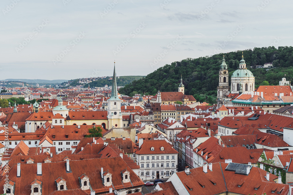Obraz premium Prague cityscape in spring. Top view of old city center ang orange roofs.